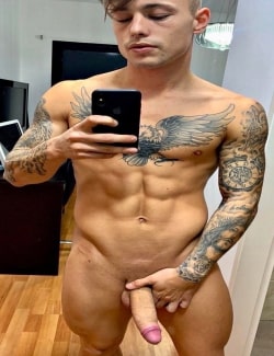 Tattooed nude guy taking selfies