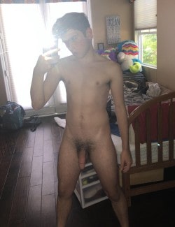Nude boy taking selfies