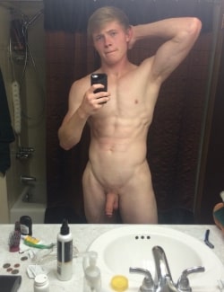 Blonde boy taking a nude selfie